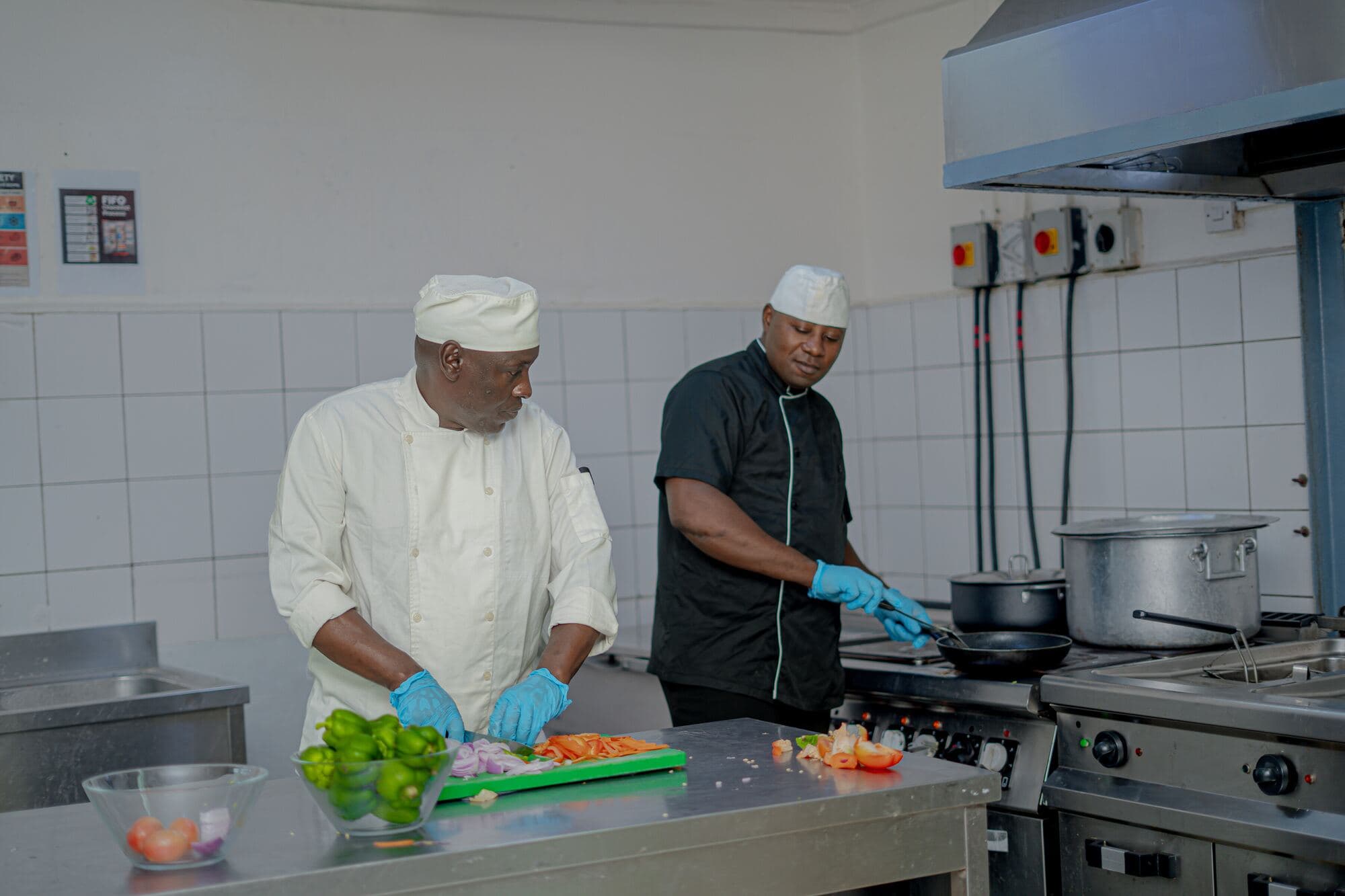 Accenti chefs preparing food in a commercial kitchen