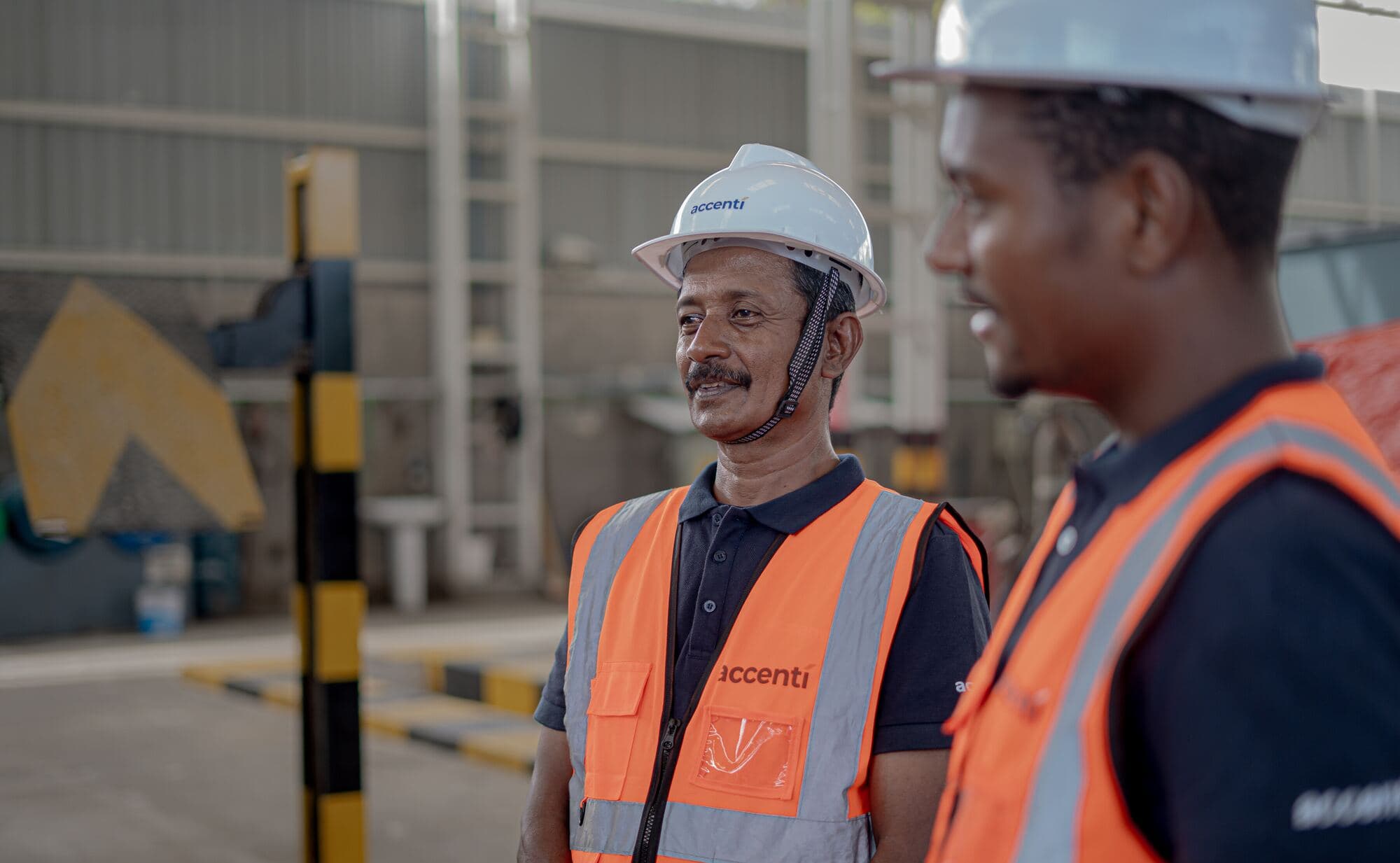 Two Accenti team members talking in the workshop