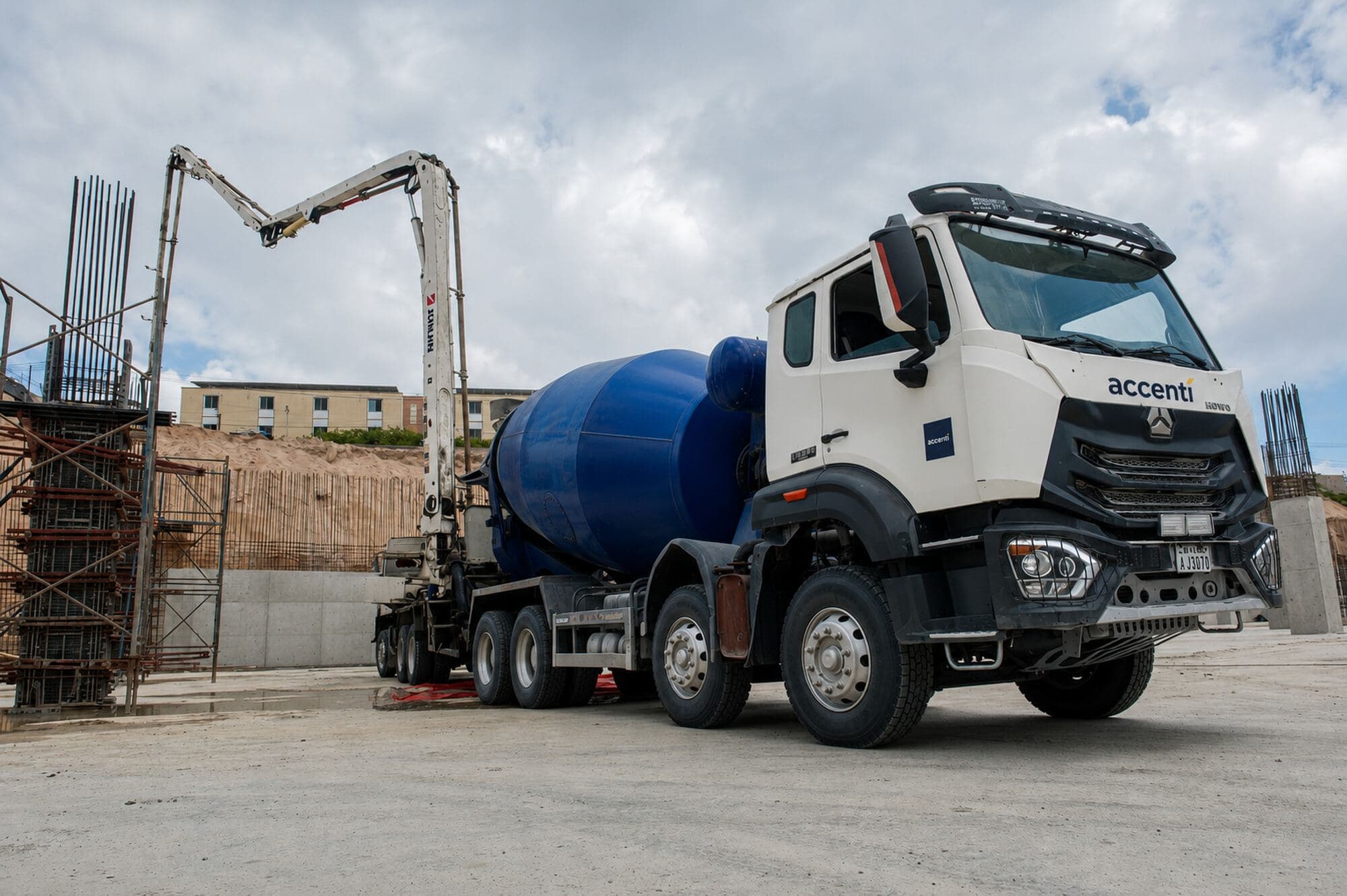 Accenti concrete mixer and truck-mounted boom pump on a building site in Mogadishu
