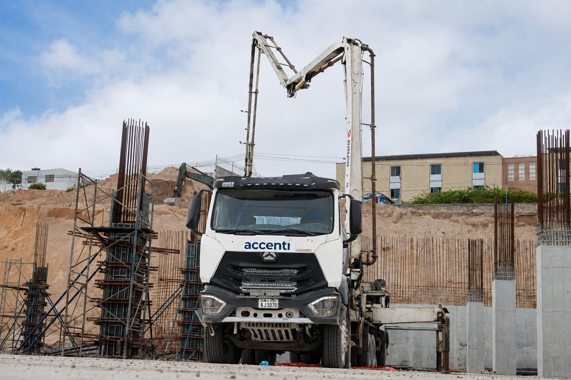 Accenti boom pump placing concrete on a reinforced concrete frame