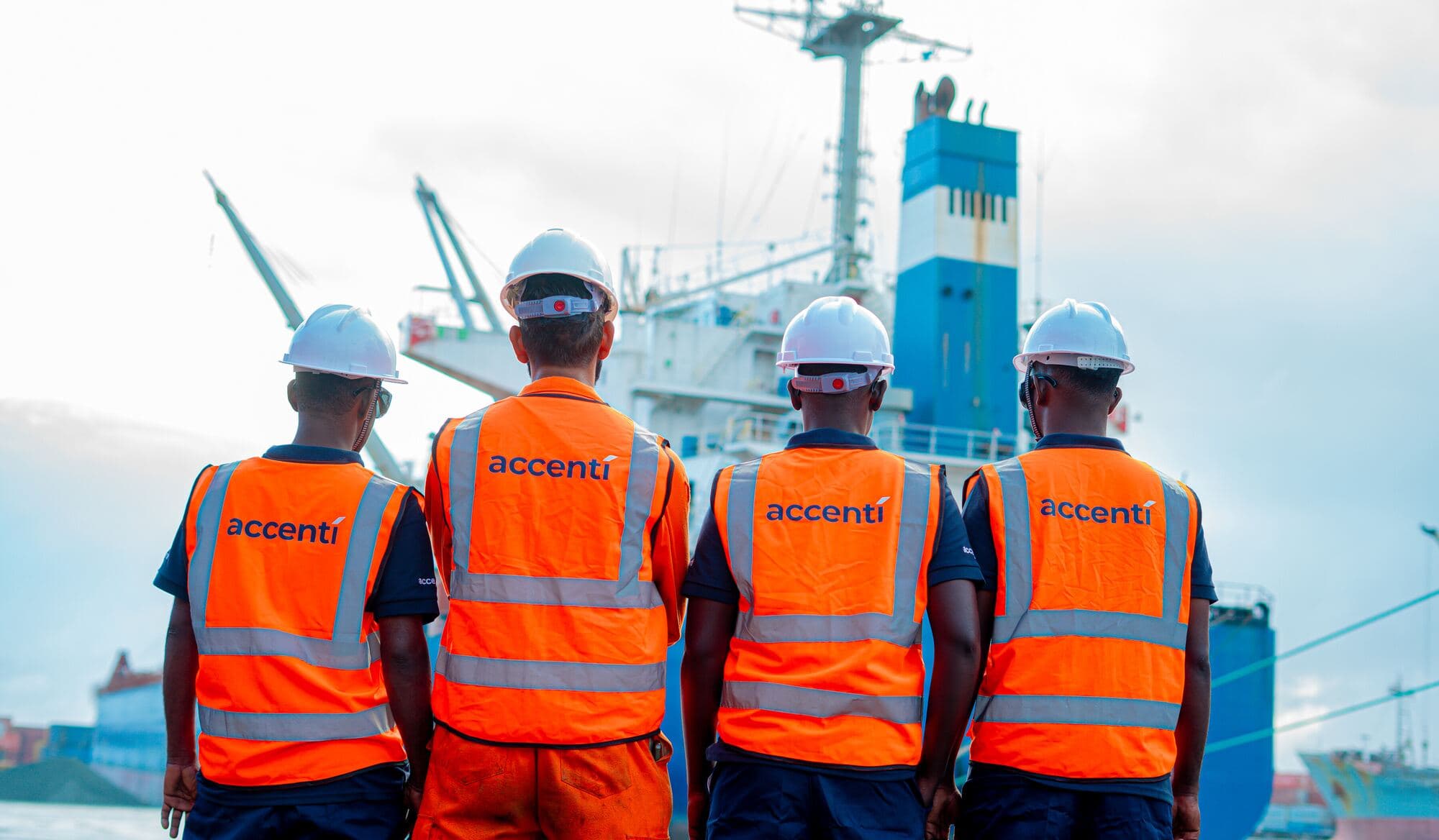 Accenti port team in high-visibility workwear facing a vessel at Mogadishu port