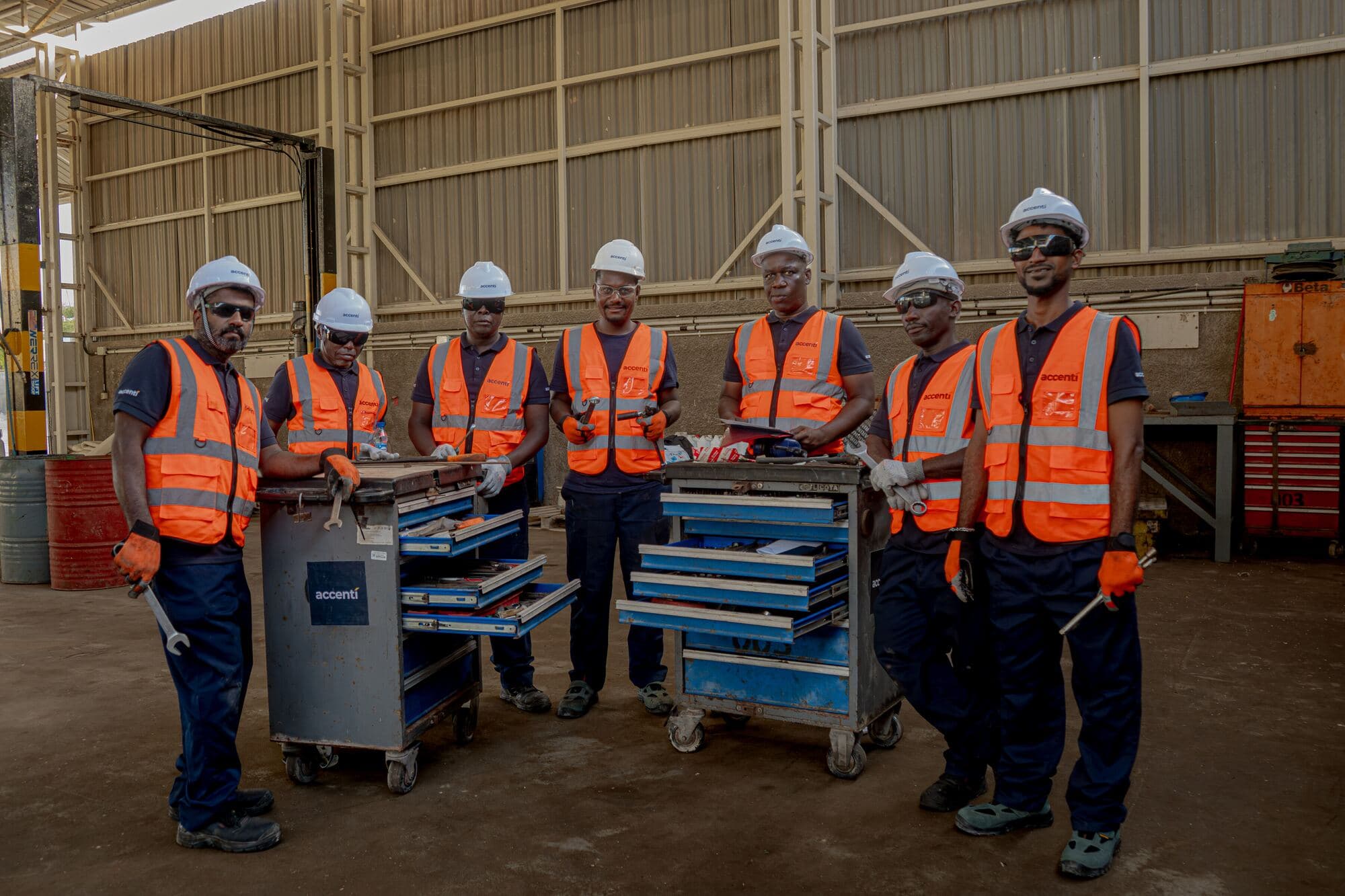 Accenti workshop team standing with tool cabinets